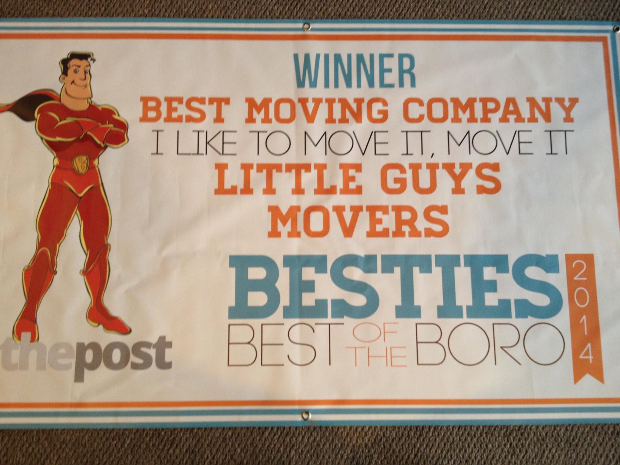 Sign announcing Little Guys Movers as best moving company