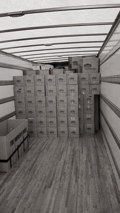 Back of a moving truck with rows of neatly-stacked boxes