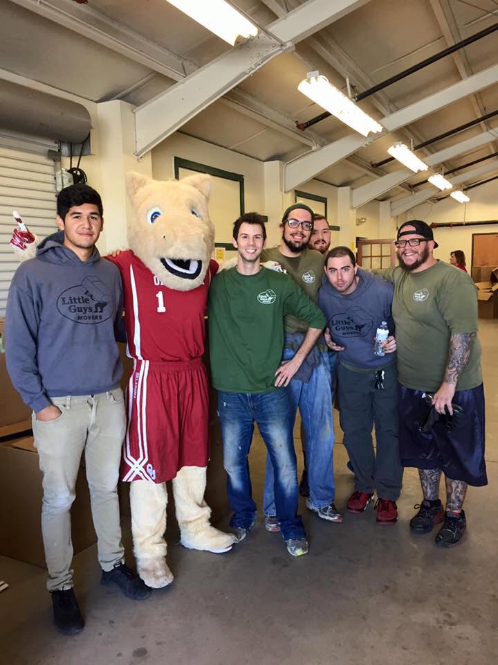 Group of movers posing with a mascot