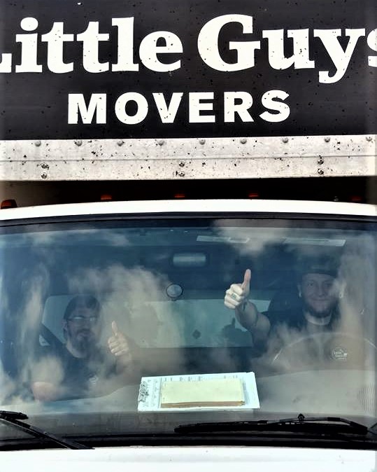 bryan college station movers giving a thumbs up inside a truck