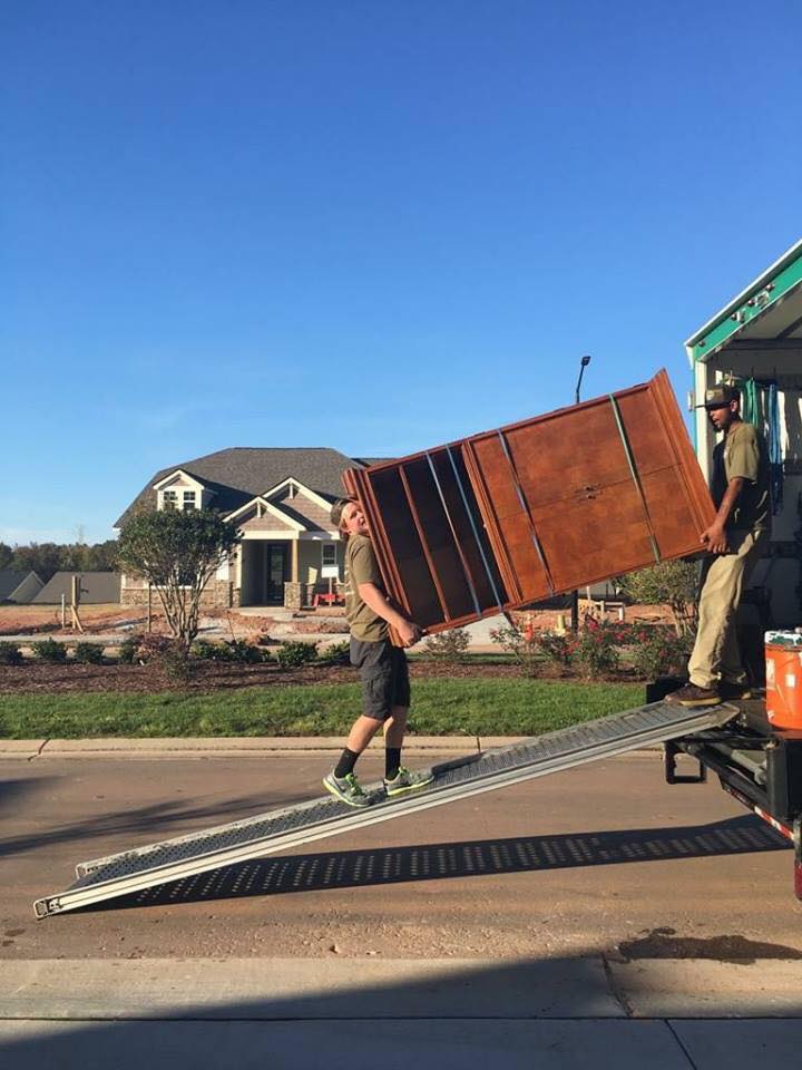 lubbock furniture movers carrying armoire