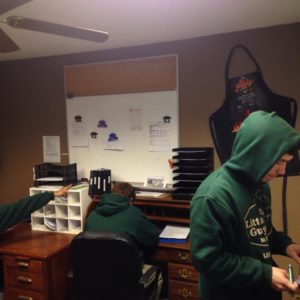 Three movers in the office working on log books