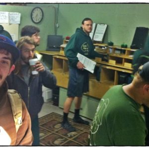 Little Guys getting coffee with one mover smiling at the camera