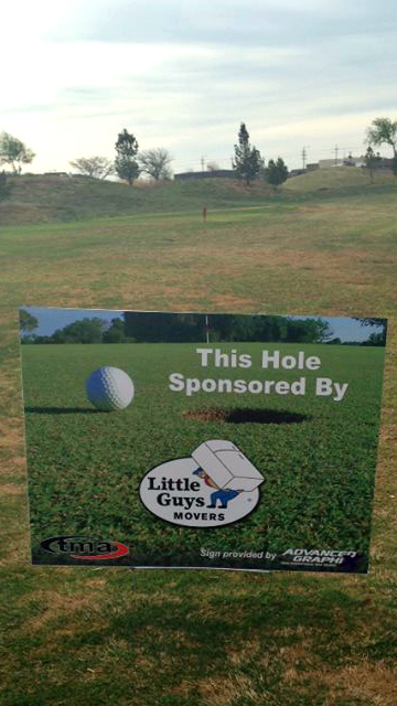 sign on golf course that says Little Guys Movers Lubbock sponsored a hoel for the Tech Marketing Association tournament