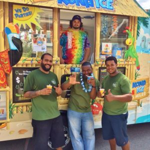 Three movers in front of Kona Ice Truck with shaved ice