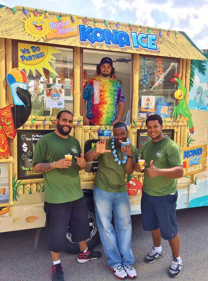Three movers in front of Kona Ice Truck with shave ice
