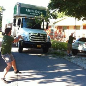 Fayetteville Little Guys cutting tree branches to fit moving truck on street