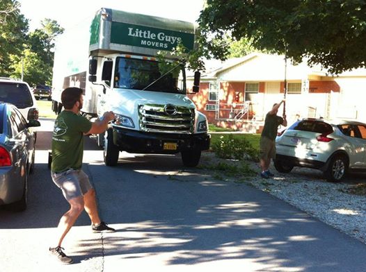 Fayetteville Little Guys cutting tree branches to fit moving truck on street