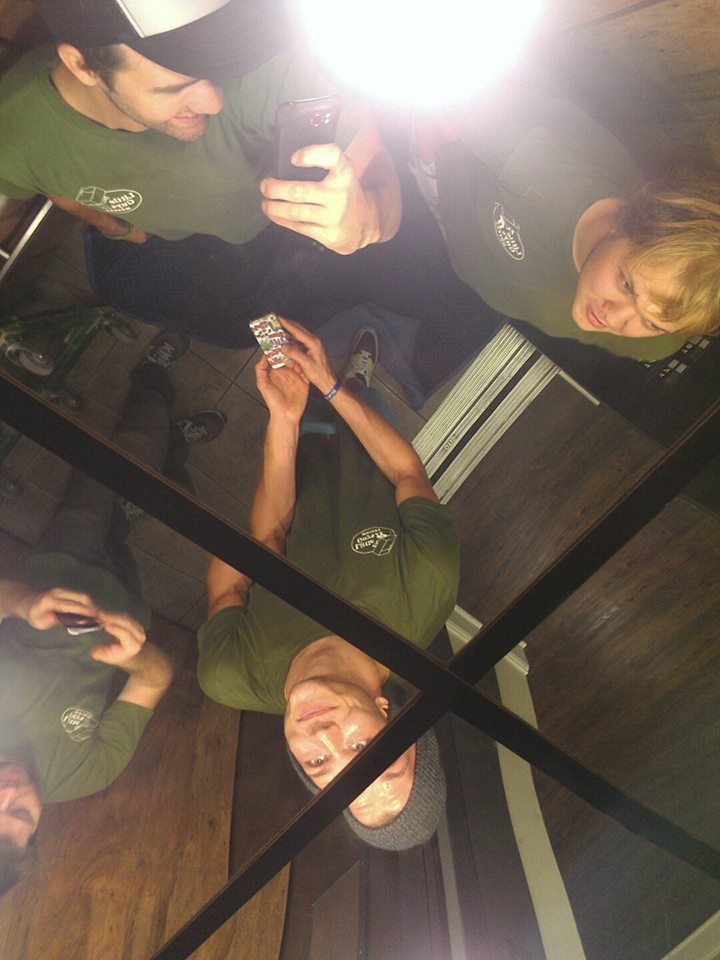 Little Guys Movers in Lexington, Kentucky pause for a Kodak moment in an elevator with a mirrored ceiling.