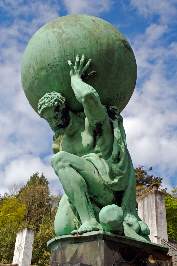 Statue of man holding globe