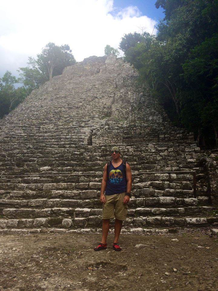 Mover standing in front of ancient landmark