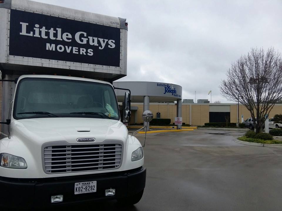 Little Guys Movers truck outside building