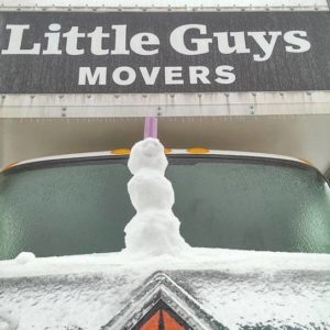mini snowman on top of Little Guys Movers truck