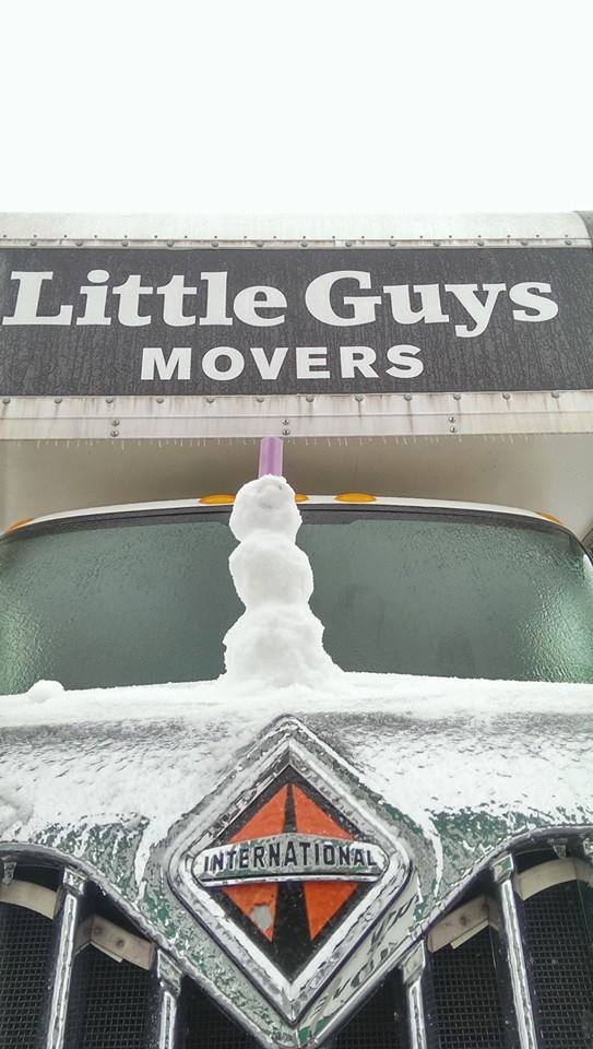 Mini snowman on top of Little Guys Movers truck