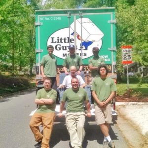 Little Guys Movers behind a moving truck