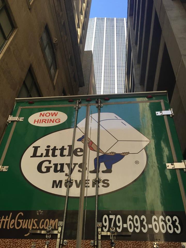 A Little Guys Movers truck in the Big City