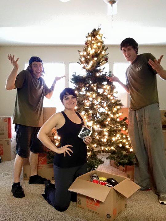 Little Guys Movers and a customer posing with a Christmas tree in Norman