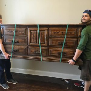 Two Little Guys Movers carrying furniture