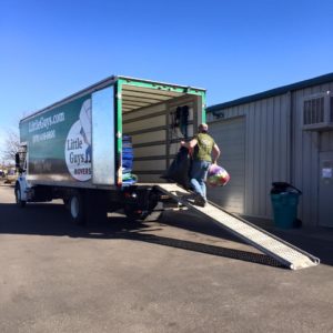 A mover loading a Little Guys truck