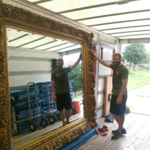 A mover loading a large mirror