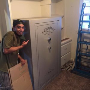 A Little Guy poses with a safe