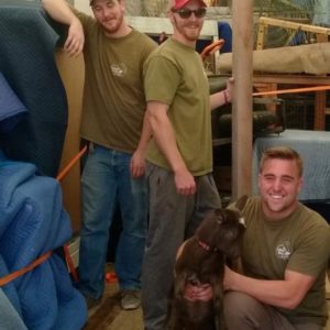 Three Little Guys posing with a goat