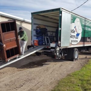 Two Little Guys loading furniture on to a moving truck