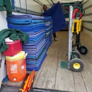 A mover inside of a Little Guys truck with equipment