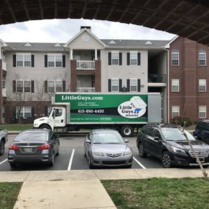 A Little Guys truck parked in front of apartments