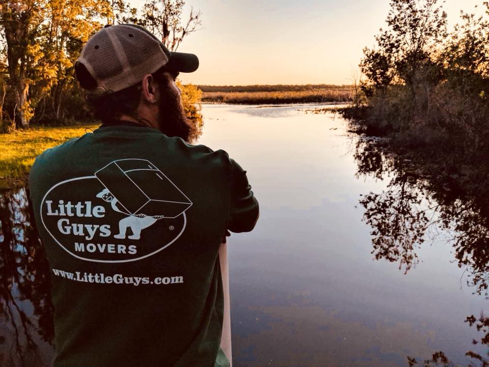 raleigh man looking at lake in Little Guys Movers shirt