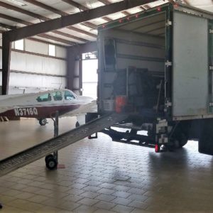 college station moving truck in aircraft hangar