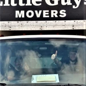 Two Little Guys Movers inside a truck