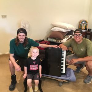 lubbock moving employees with small piano and child