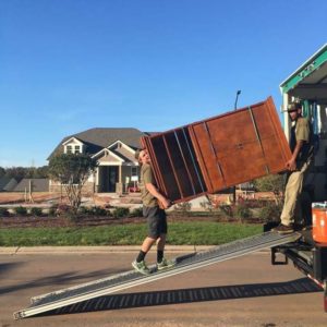 Lubbock furniture movers carrying armoire