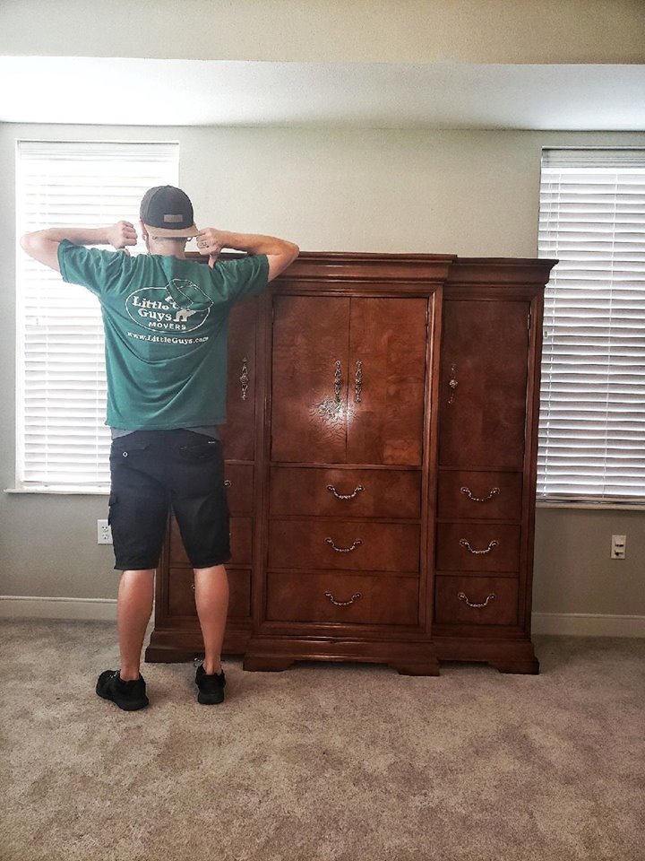 College Station mover with armoire in Little Guys shirt