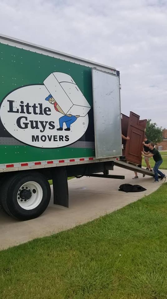 Little Guys Movers with heavy furniture and truck