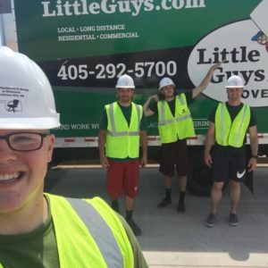 Norman Little Guys Movers truck with movers in safety gear in front