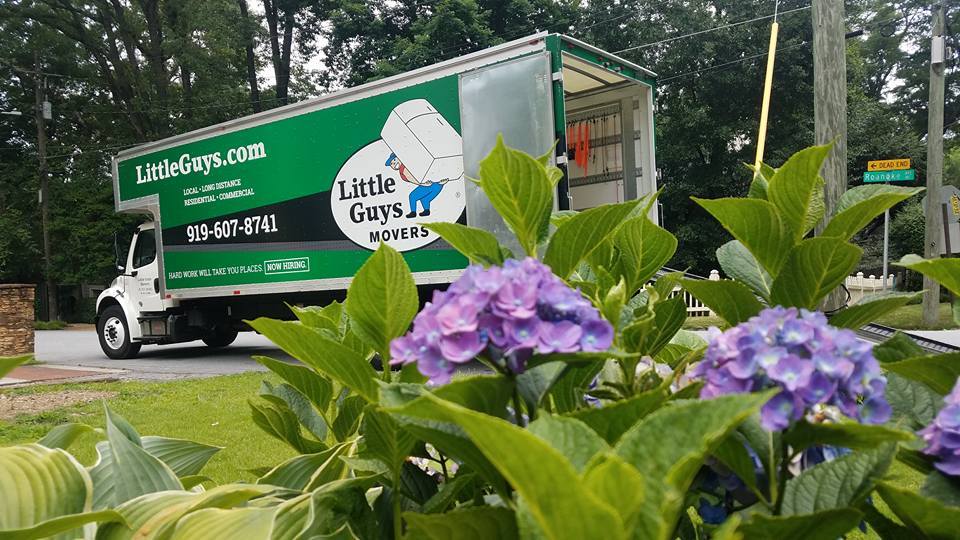 raleigh moving truck outside with summer flowers