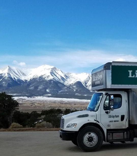 moving truck in front of mountain 