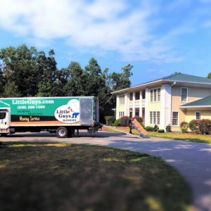 A Greensboro Little Guys Movers truck outside home