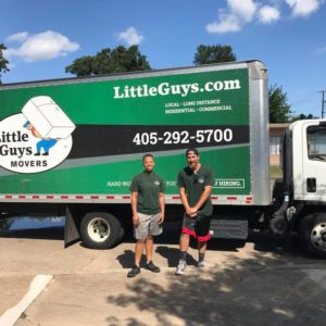 Two Little Guys Movers in front of a moving truck