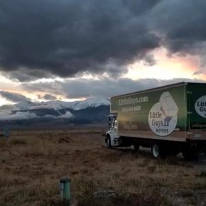 little guys movers fort collins truck in front of mountains