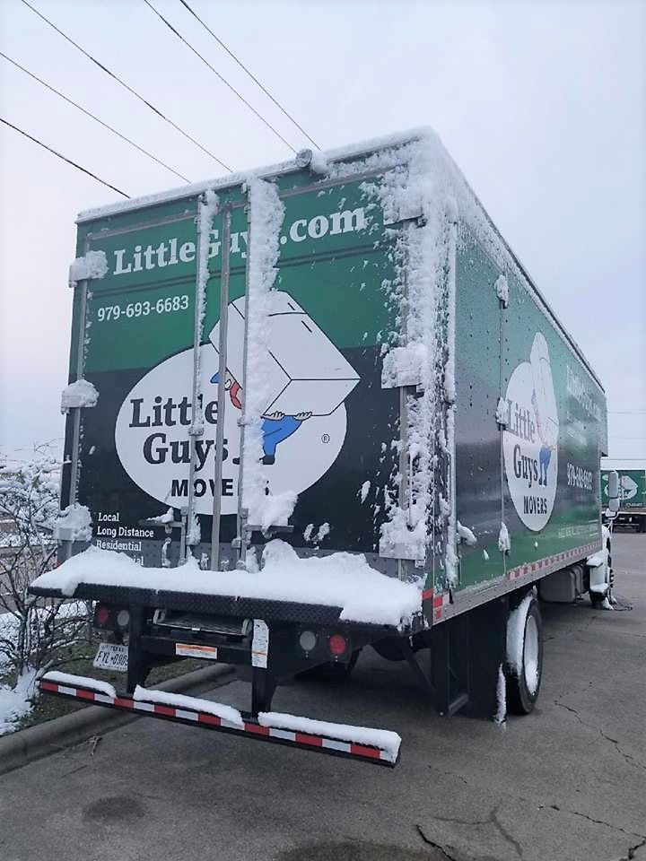 little guys movers truck covered in snow