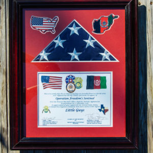 a framed American flag and certificate of dedication of the combat flag flown in Afghanistan on September 17, 2018.