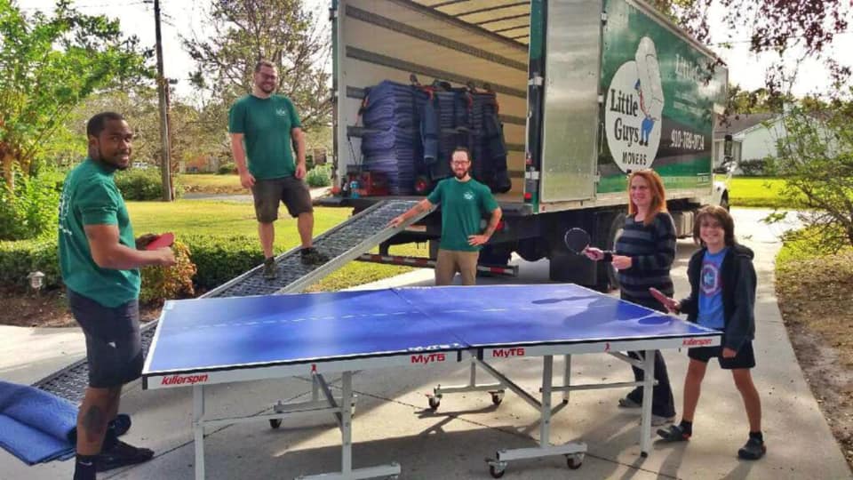 lexington professional movers playing ping pong with customers in front of little guys movers truck