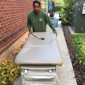 Raleigh corporate movers moving a doctor's table