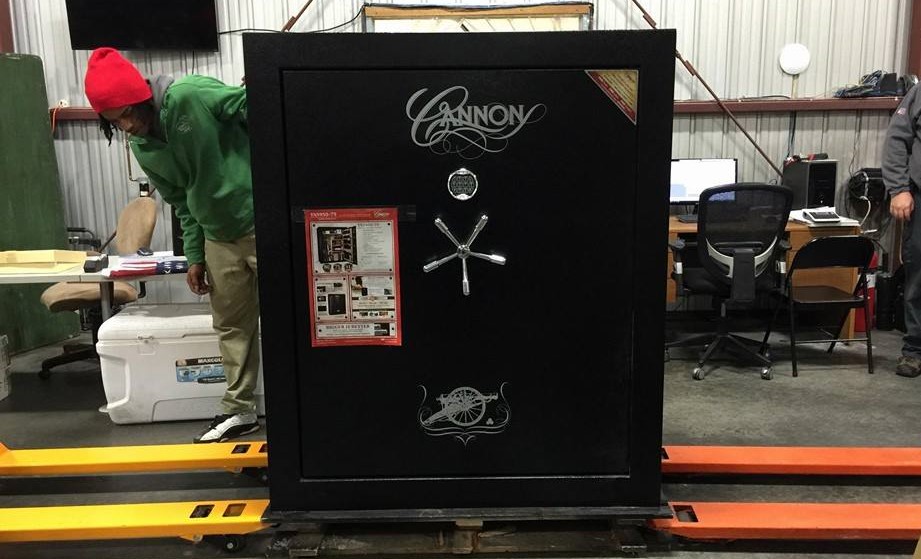 A Little Guy from the Murfreesboro store inspects a large, heavy black safe.