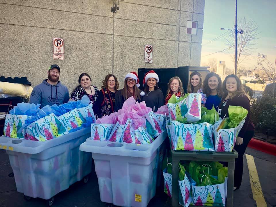 Jackson L Graves Foundation volunteers with toys for children