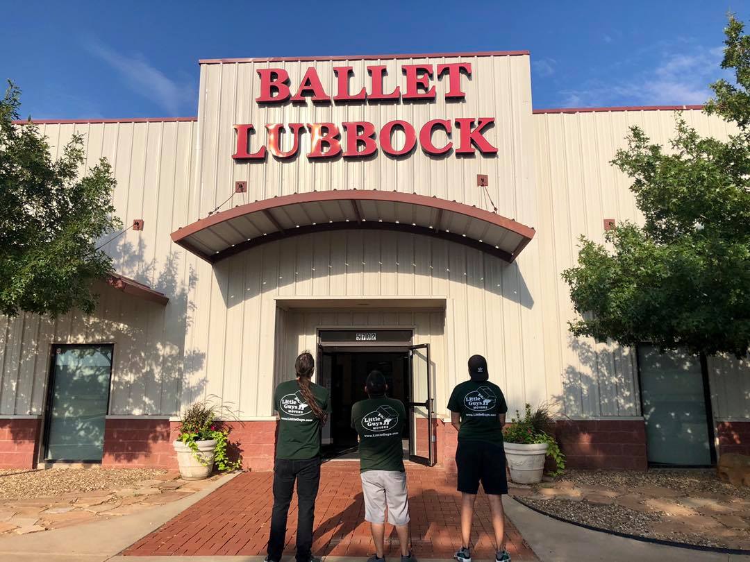 Three movers in front of Ballet Lubbock building