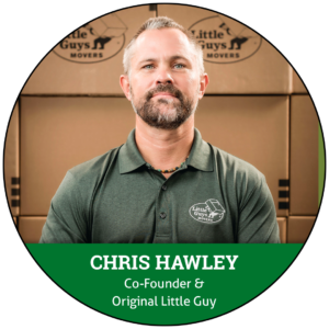A headshot of Little Guys Movers Co-Founder Chris Hawley in front of Little Guys Movers-branded moving boxes, encompassed within a circle image